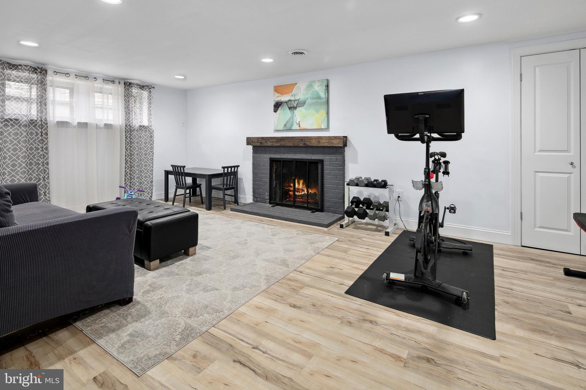 1212 Dale Drive Silver Spring, MD 20910 - Photo 35 of 59 a living room with furniture a fireplace and a flat screen tv