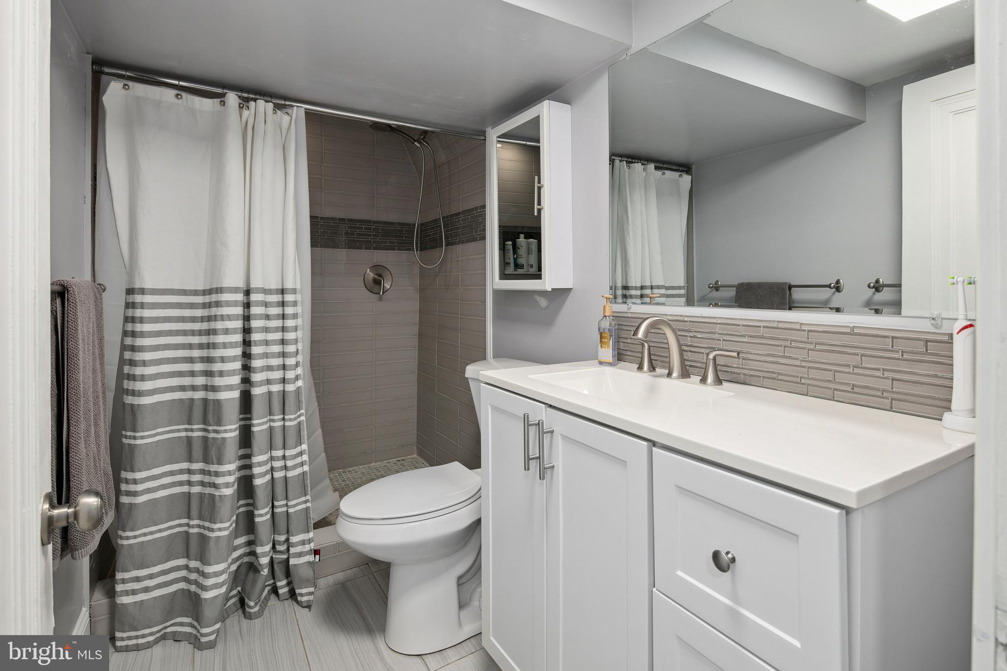 1212 Dale Drive Silver Spring, MD 20910 - Photo 46 of 59 a bathroom with a sink toilet and shower