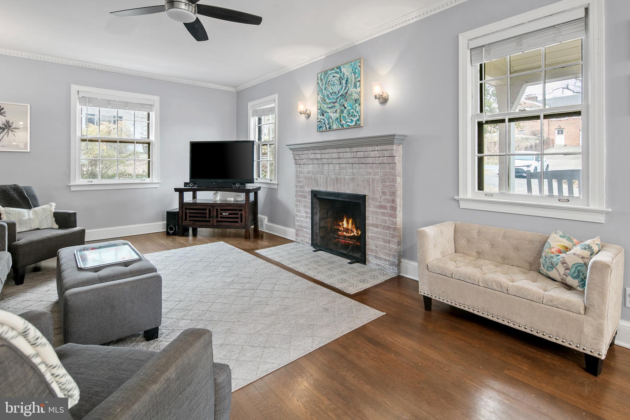 1212 Dale Drive Silver Spring, MD 20910 - Photo 5 of 59 a living room with furniture a flat screen tv and a fireplace