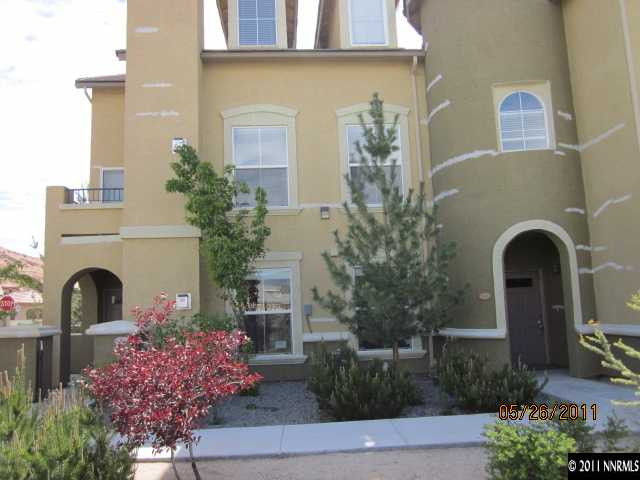 a front view of a house with plants