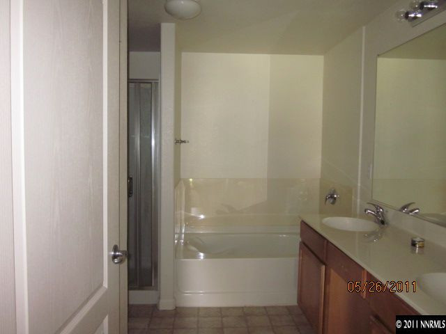 9050 Double R Boulevard, Unit 111 Reno, NV 89511 - Photo 7 of 8 a bathroom with a shower and a sink