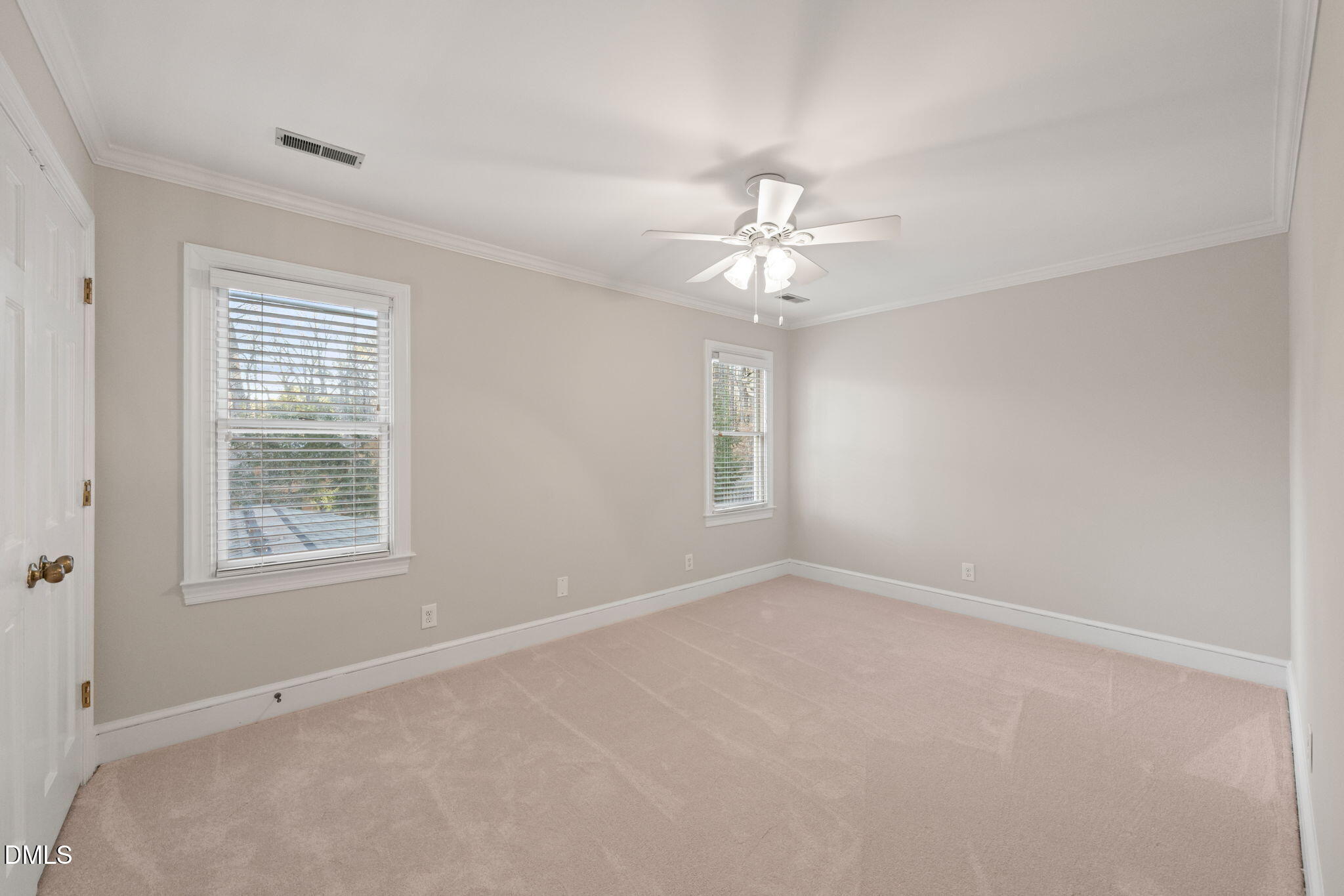 2300 Vly Frg Road Raleigh, NC 27615 - Photo 38 of 62 an empty room with chandelier fan and windows