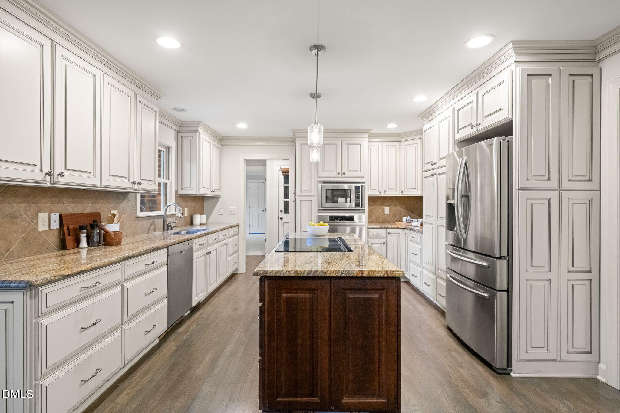 2300 Vly Frg Road Raleigh, NC 27615 - Photo 7 of 62 a kitchen with stainless steel appliances granite countertop a refrigerator a sink dishwasher a stove and white cabinets with wooden floor
