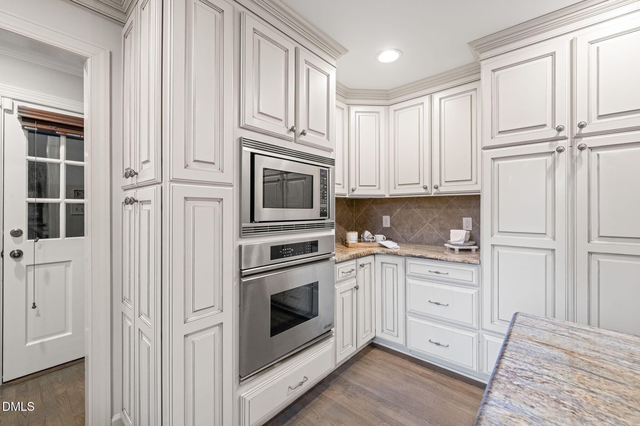 2300 Vly Frg Road Raleigh, NC 27615 - Photo 9 of 62 a kitchen with white cabinets and white appliances