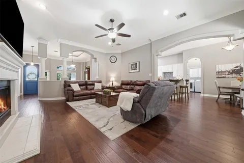 a living room with furniture a fireplace and a flat screen tv