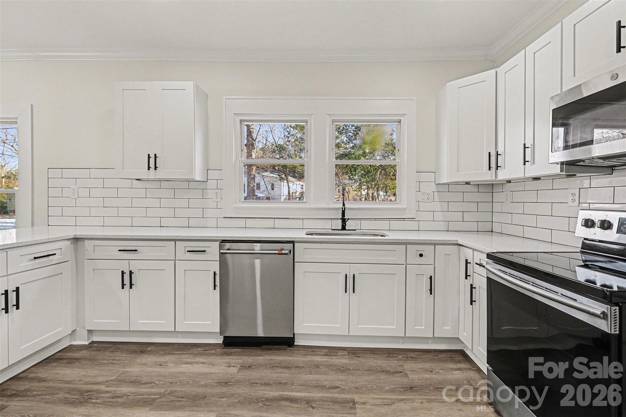 1013 Ridge Avenue Gastonia, NC 28052 - Photo 11 of 33 a kitchen with stainless steel appliances white cabinets and a stove top oven