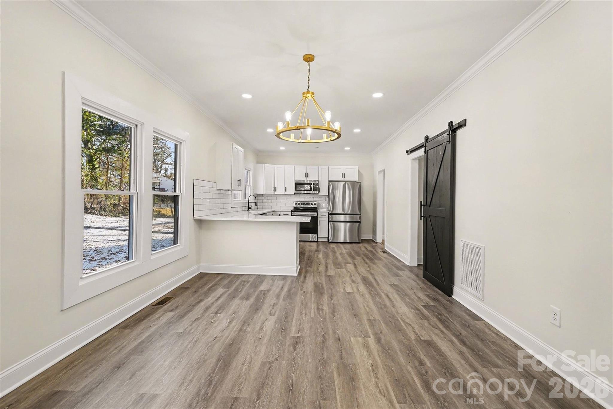 1013 Ridge Avenue Gastonia, NC 28052 - Photo 12 of 33 a view of a kitchen with wooden floor electronic appliances and window