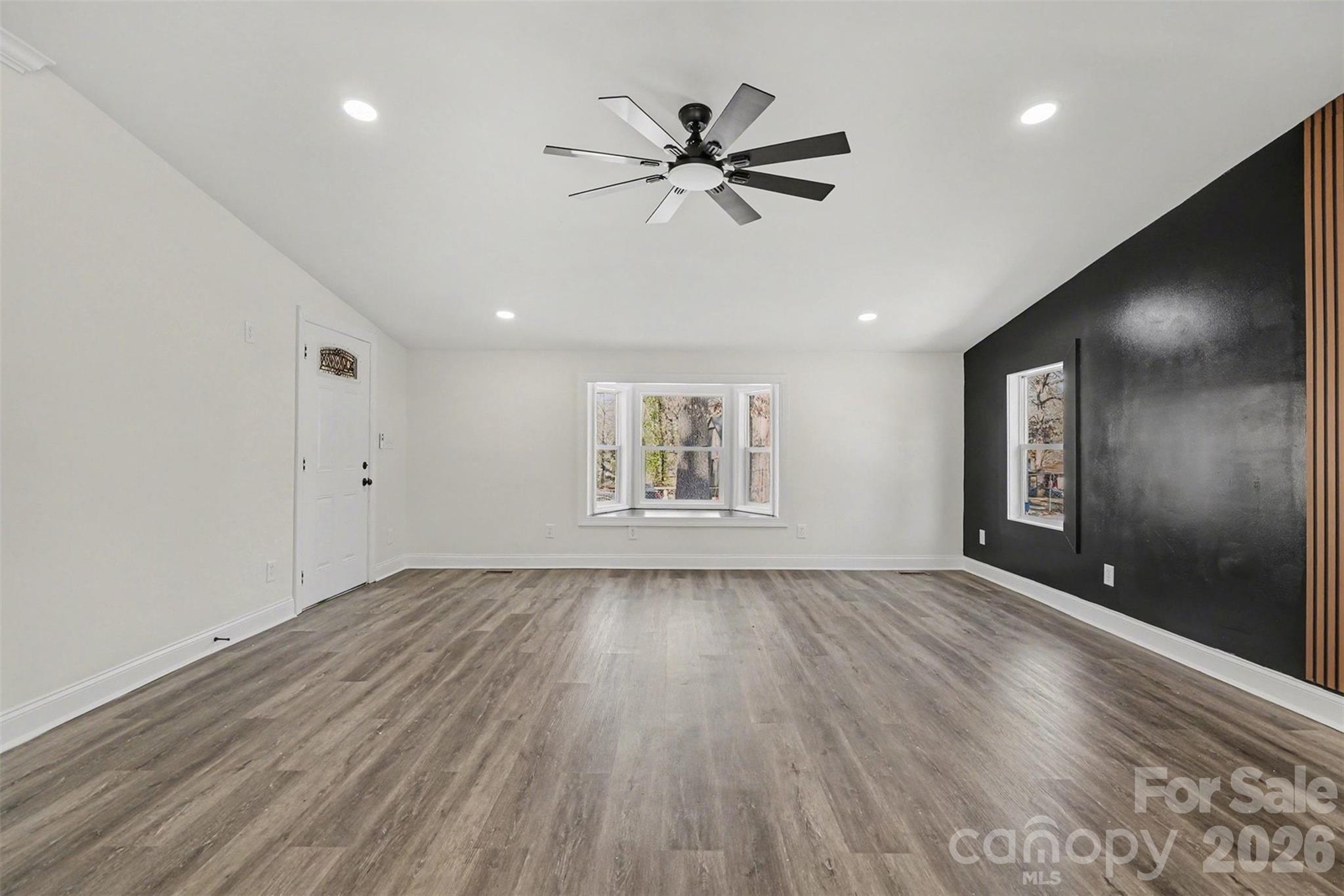 1013 Ridge Avenue Gastonia, NC 28052 - Photo 5 of 33 a view of an empty room with a window and wooden floor