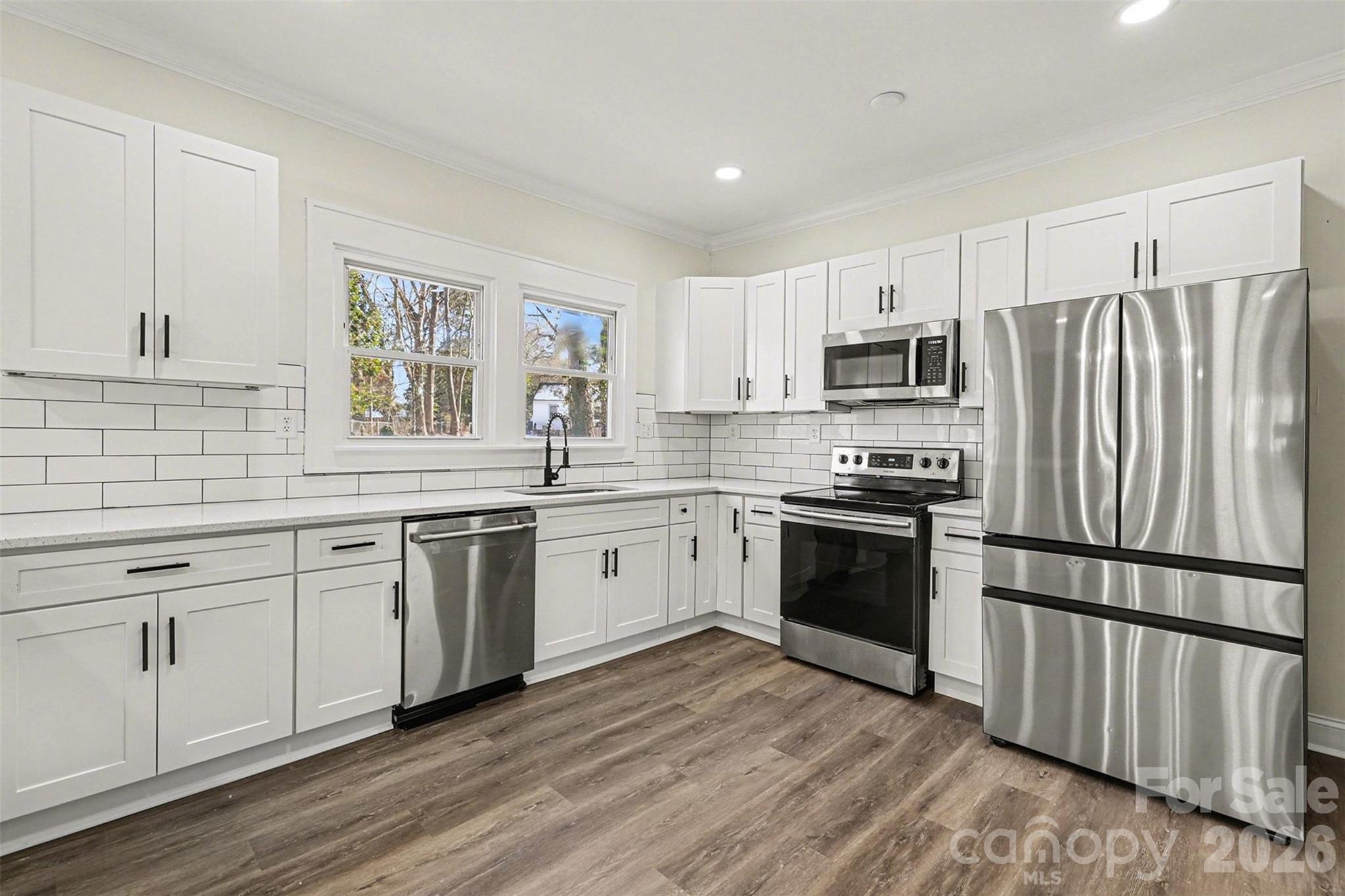 1013 Ridge Avenue Gastonia, NC 28052 - Photo 10 of 33 a kitchen with granite countertop a refrigerator stove top oven and sink