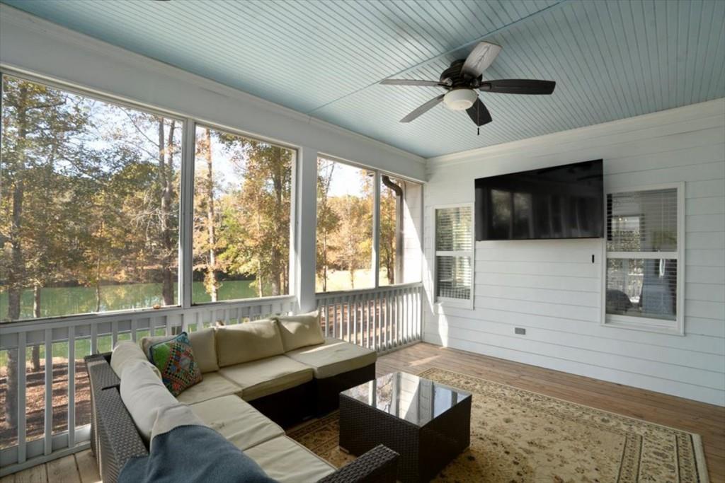 3055 Spring Hill Drive Monroe, GA 30656 - Photo 14 of 64 a living room with furniture floor to ceiling window hardwood floor and a flat screen tv