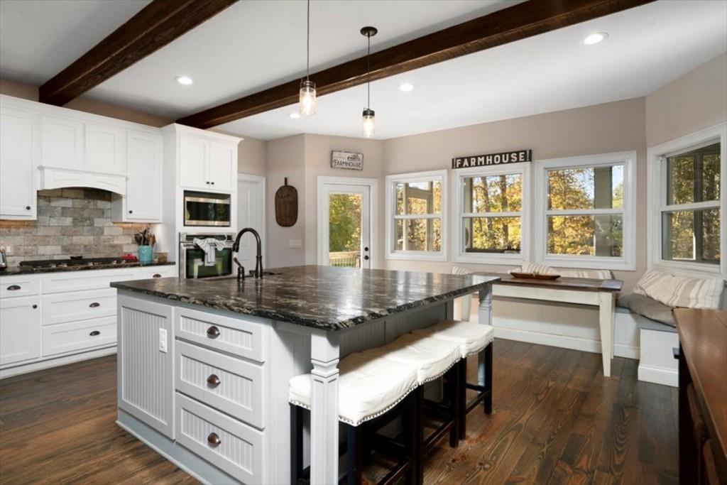 3055 Spring Hill Drive Monroe, GA 30656 - Photo 17 of 64 a kitchen with granite countertop a stove a sink and white cabinets with wooden floor