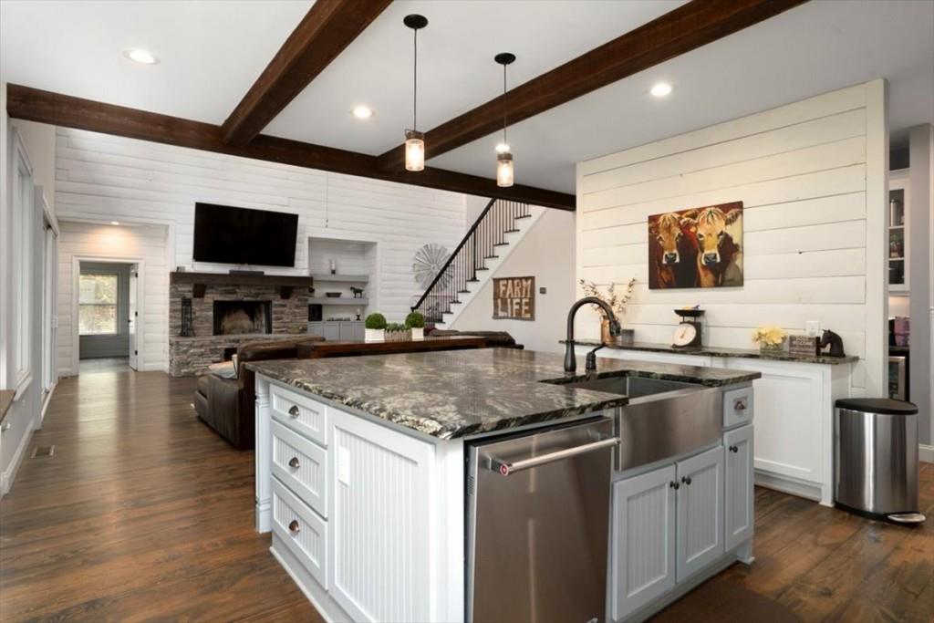 3055 Spring Hill Drive Monroe, GA 30656 - Photo 20 of 64 a kitchen with stainless steel appliances granite countertop a sink a stove top oven a counter space and cabinets
