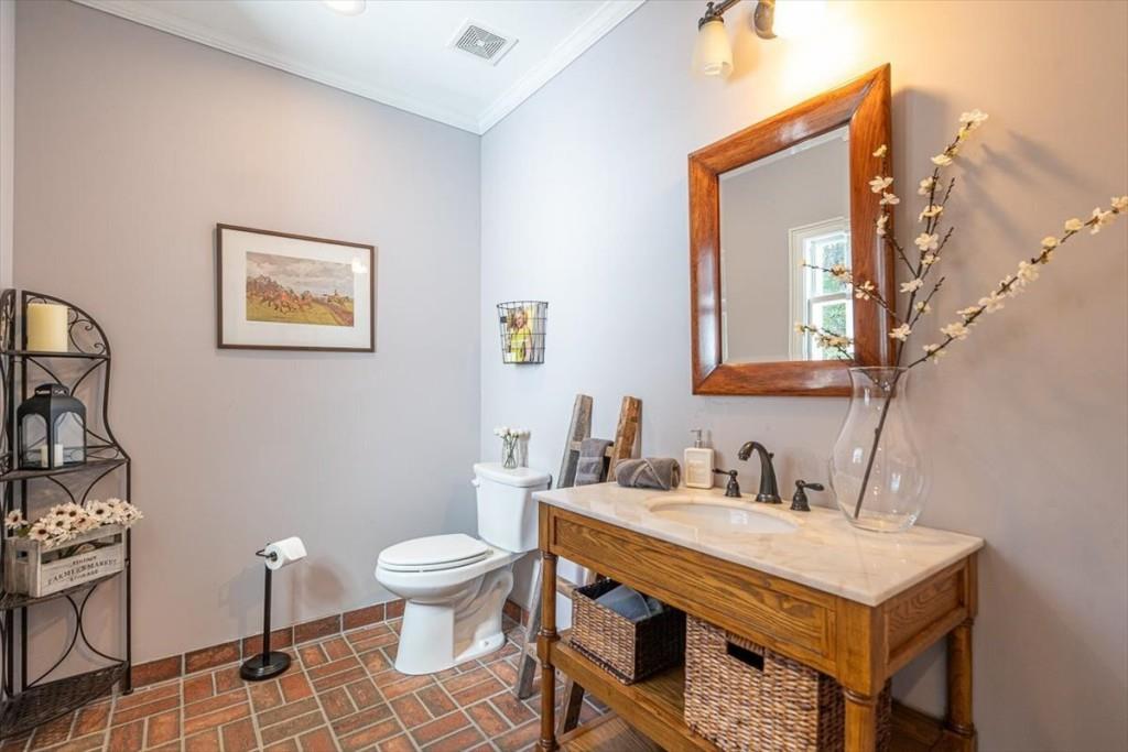 3055 Spring Hill Drive Monroe, GA 30656 - Photo 23 of 64 a bathroom with a toilet a sink and a mirror
