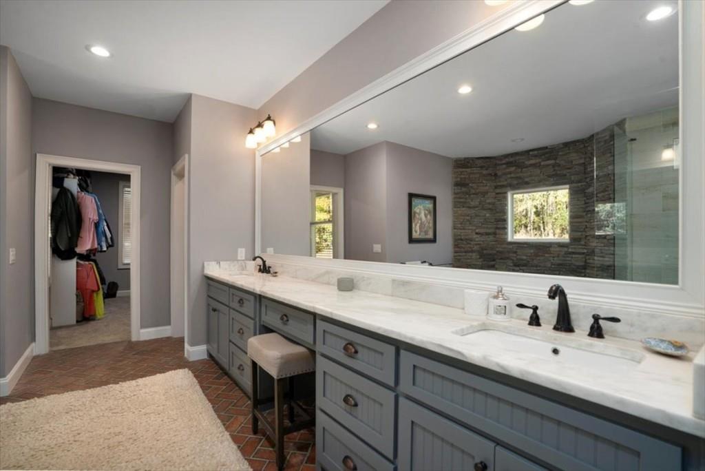 3055 Spring Hill Drive Monroe, GA 30656 - Photo 29 of 64 a bathroom with a double vanity sink and a mirror