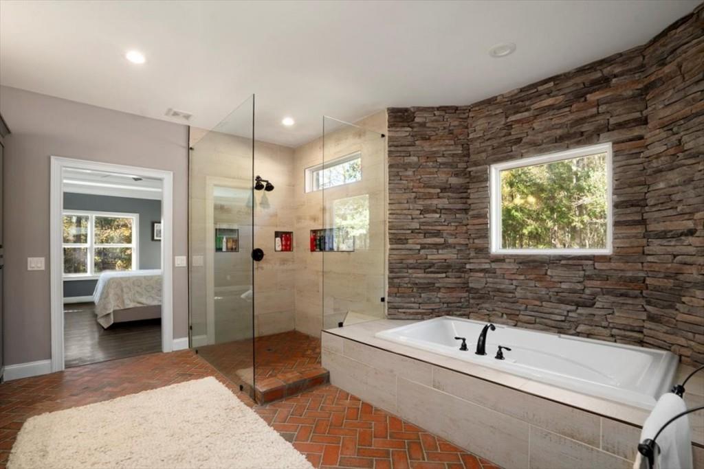 3055 Spring Hill Drive Monroe, GA 30656 - Photo 30 of 64 a bathroom with a tub a sink and a shower