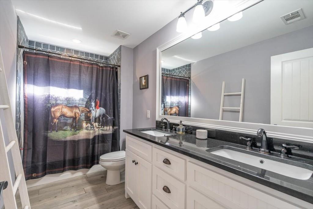 3055 Spring Hill Drive Monroe, GA 30656 - Photo 35 of 64 a bathroom with a double vanity sink toilet mirror and shower