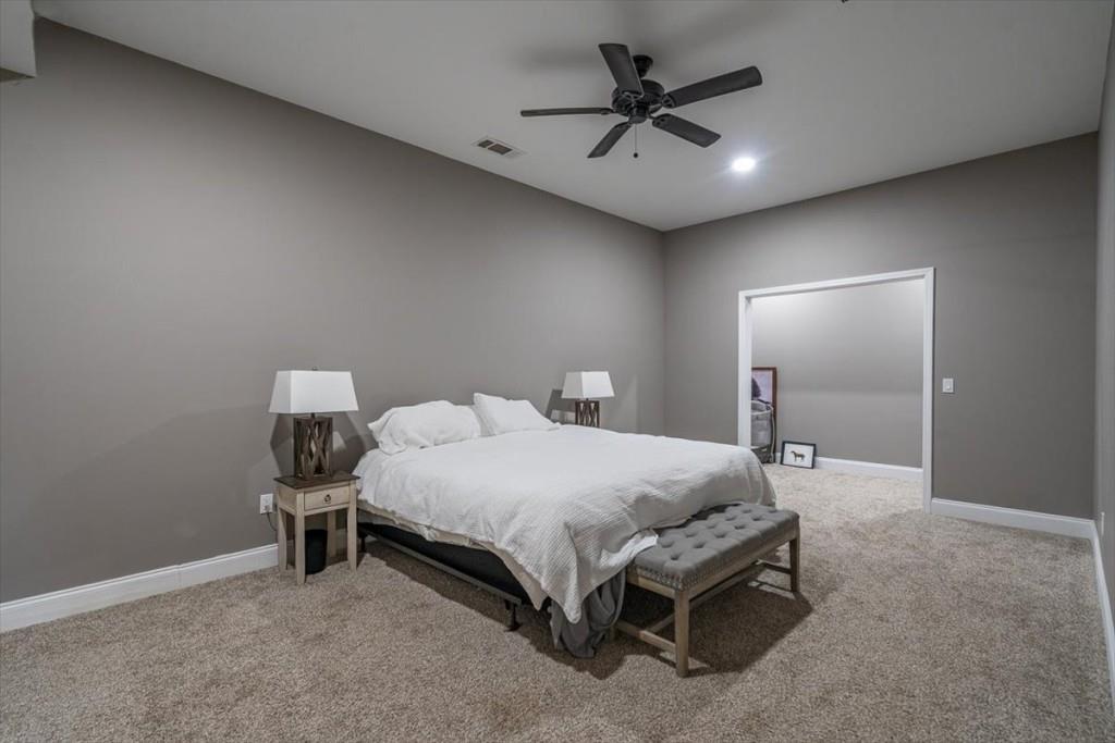 3055 Spring Hill Drive Monroe, GA 30656 - Photo 38 of 64 a bedroom with a bed and a chandelier