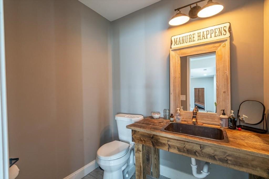 3055 Spring Hill Drive Monroe, GA 30656 - Photo 39 of 64 a bathroom with a sink a toilet and mirror