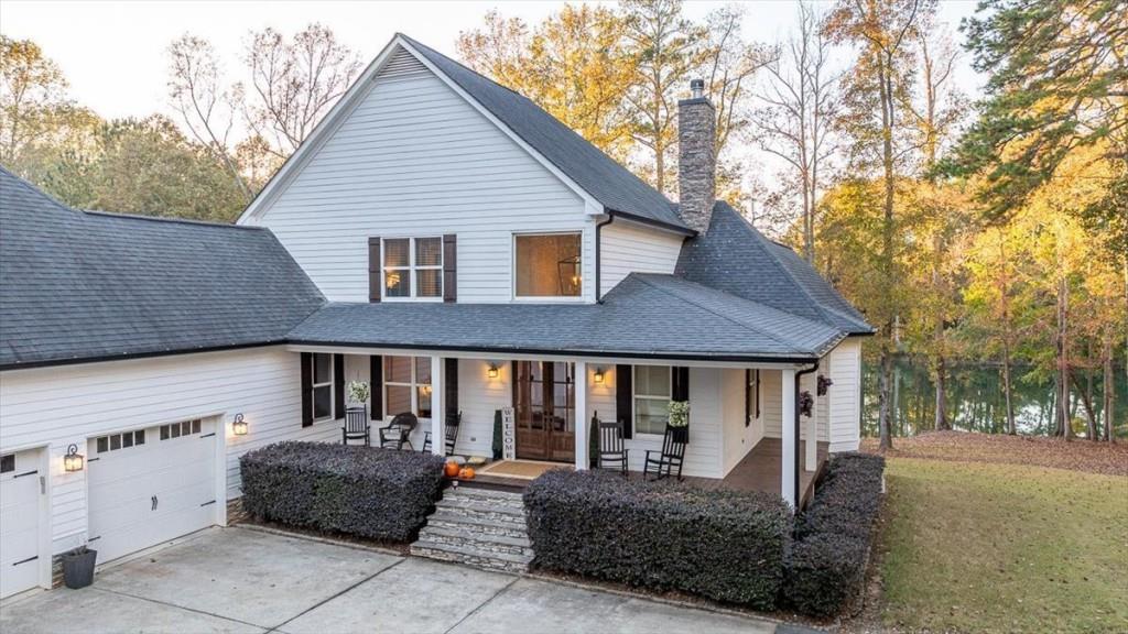 3055 Spring Hill Drive Monroe, GA 30656 - Photo 5 of 64 a front view of a house with a yard outdoor seating and garage