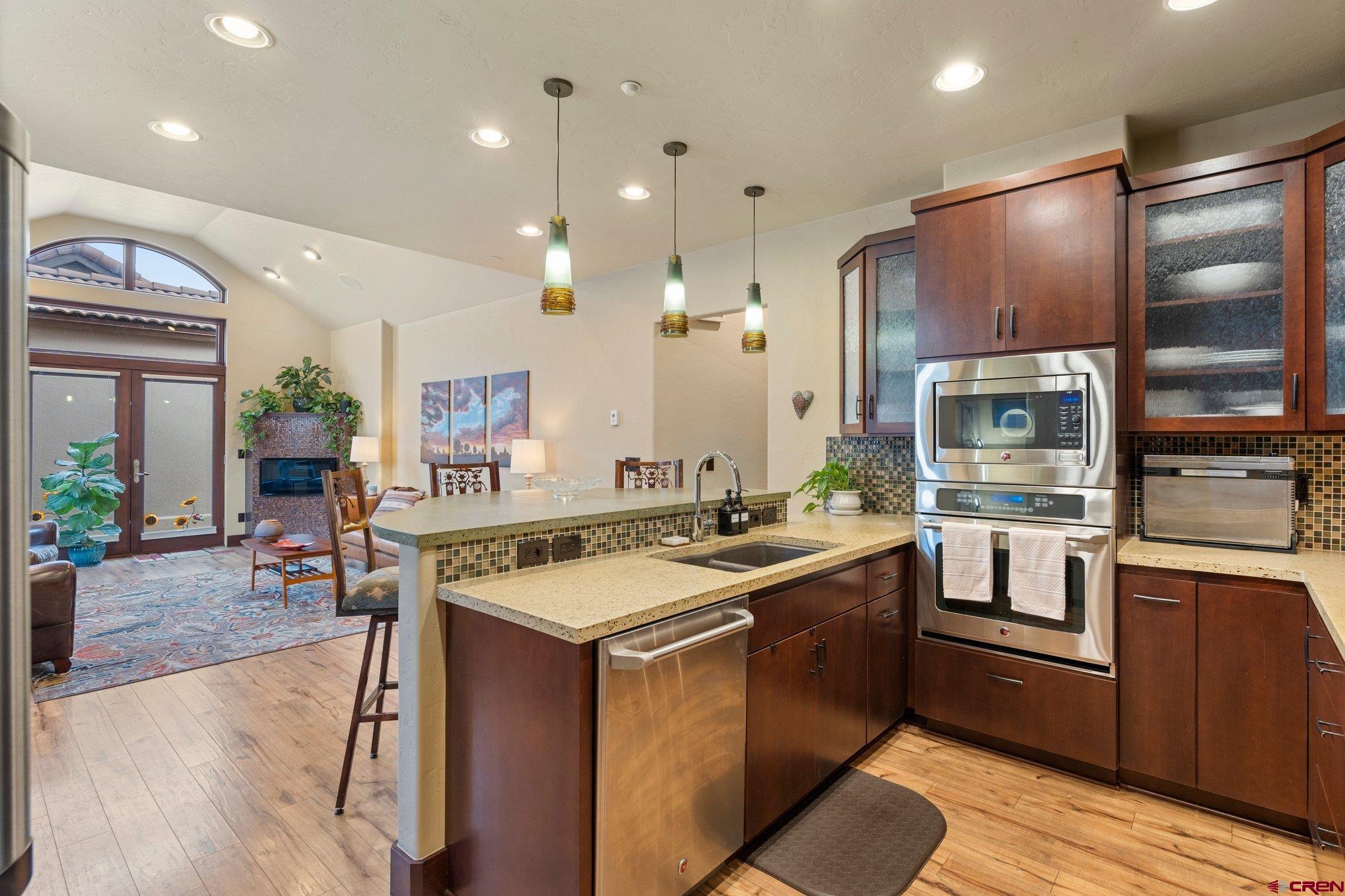 a kitchen with stainless steel appliances granite countertop a sink stove and refrigerator