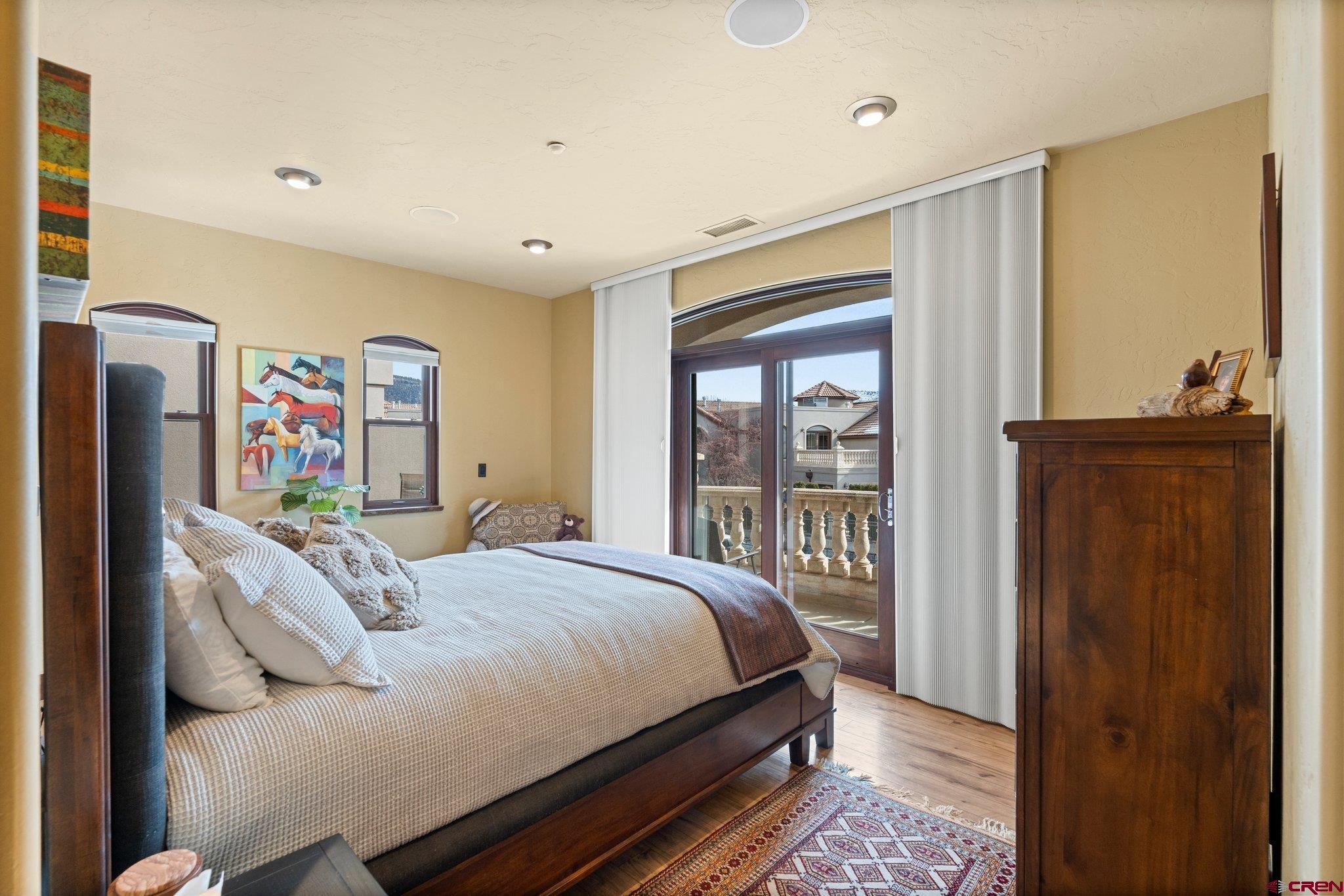3416 Main Avenue, Unit 203 Durango, CO 81301 - Photo 14 of 34 a bedroom with a bed and wooden floor