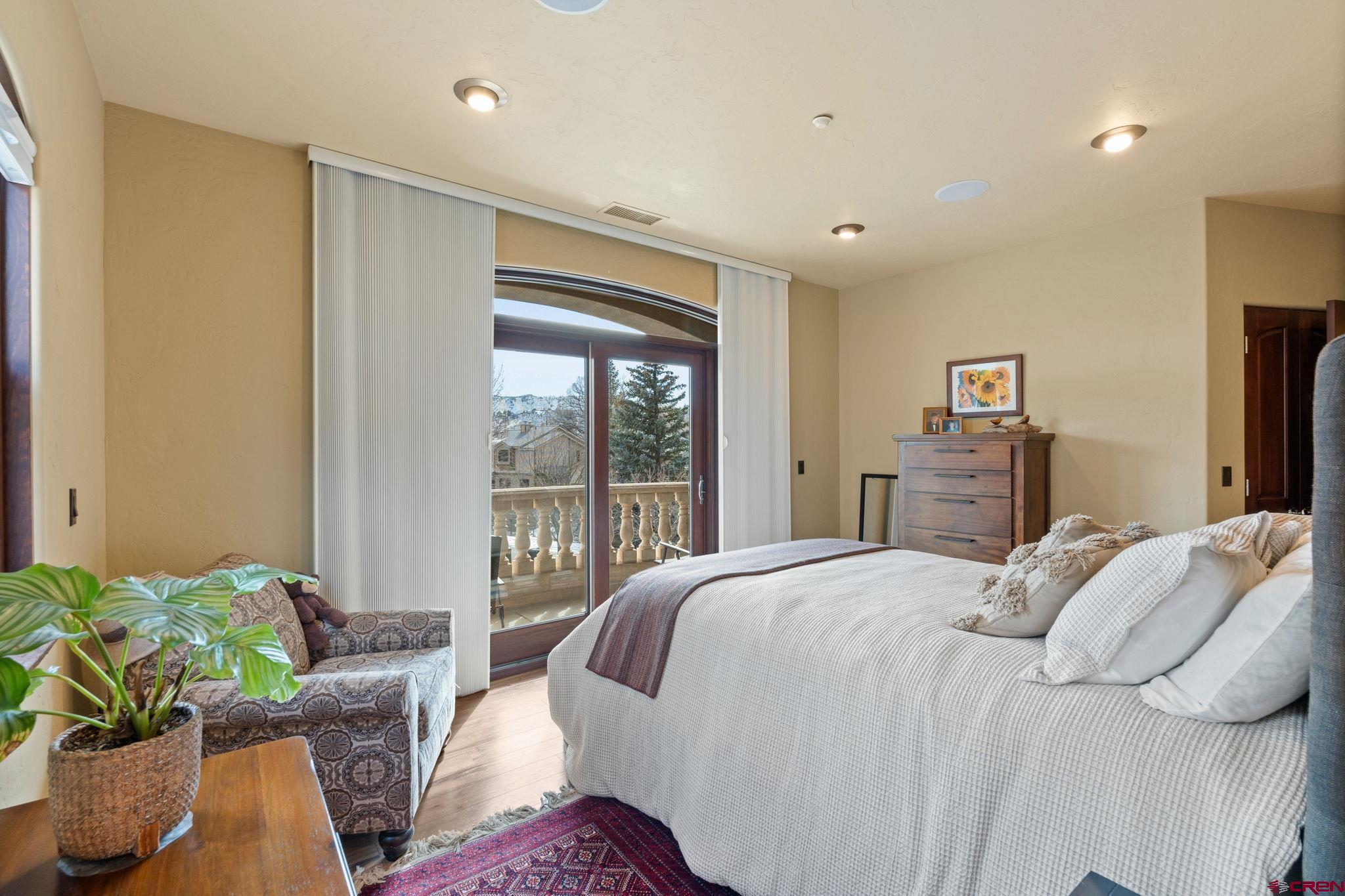 3416 Main Avenue, Unit 203 Durango, CO 81301 - Photo 15 of 34 a bedroom with bed and glass windows