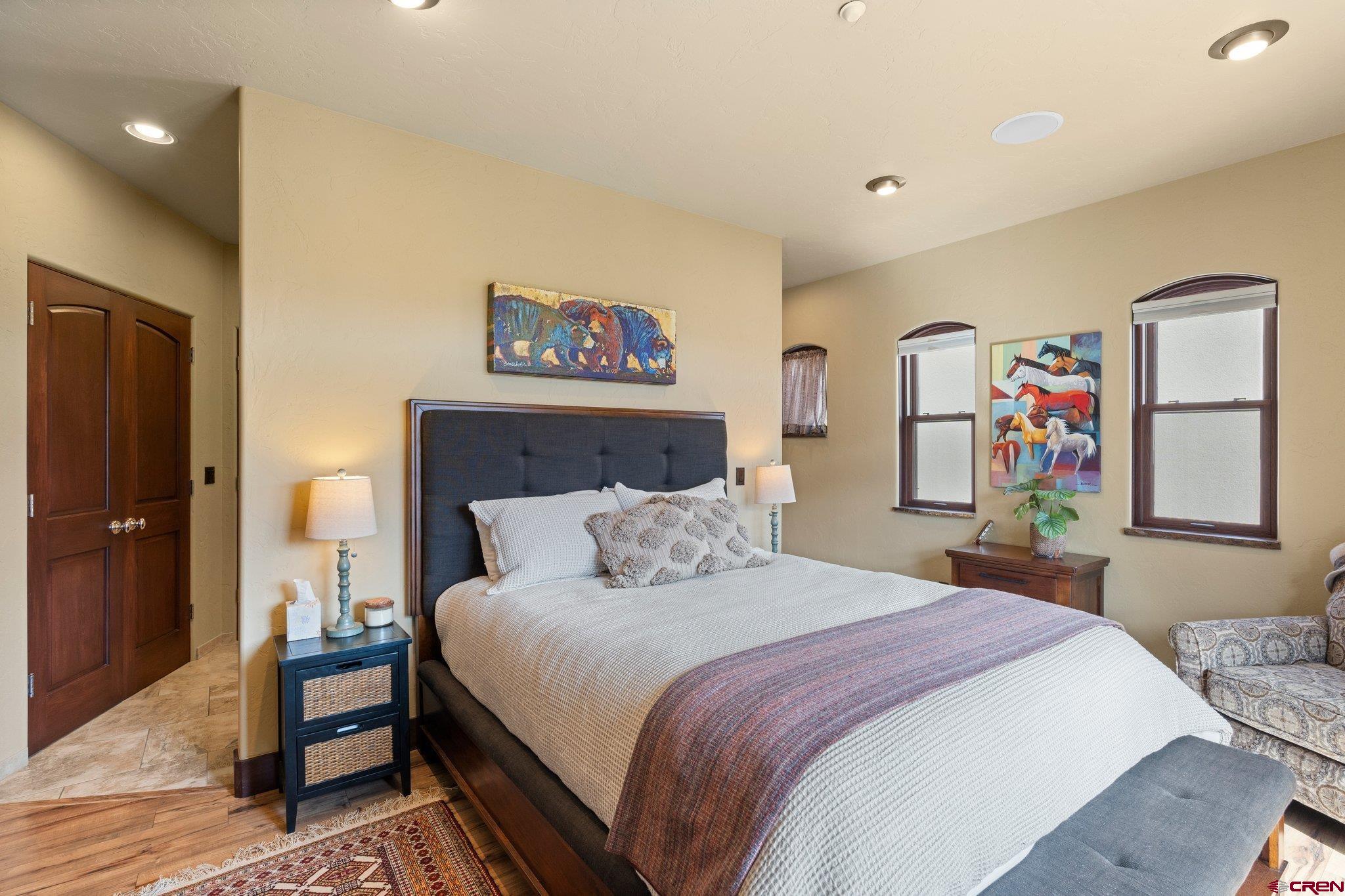 3416 Main Avenue, Unit 203 Durango, CO 81301 - Photo 16 of 34 a bedroom with a bed and a wall painting