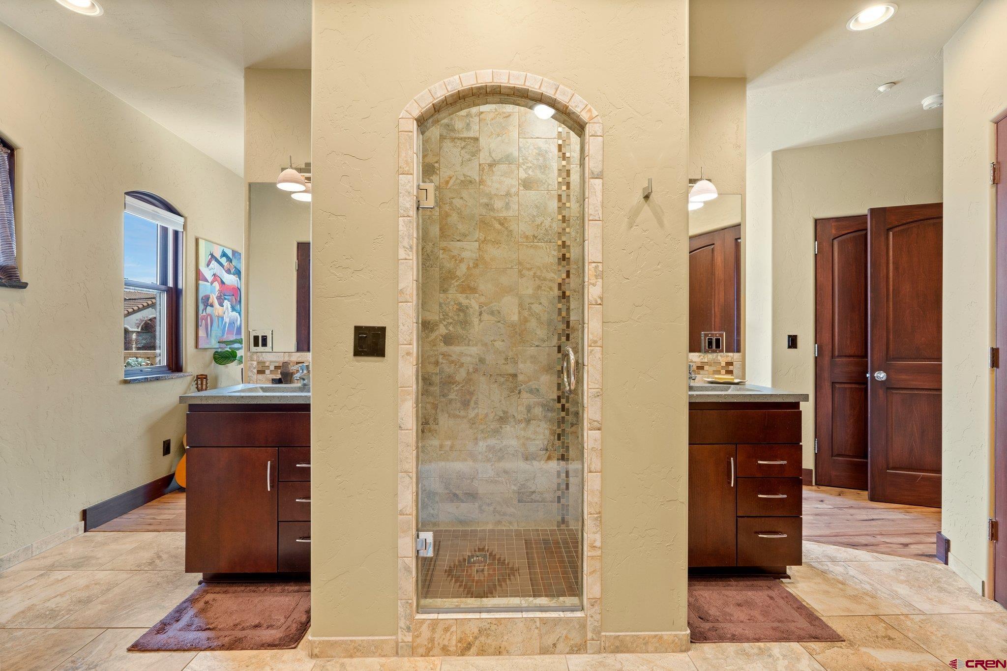3416 Main Avenue, Unit 203 Durango, CO 81301 - Photo 19 of 34 a bathroom with a granite countertop sink a mirror and a shower