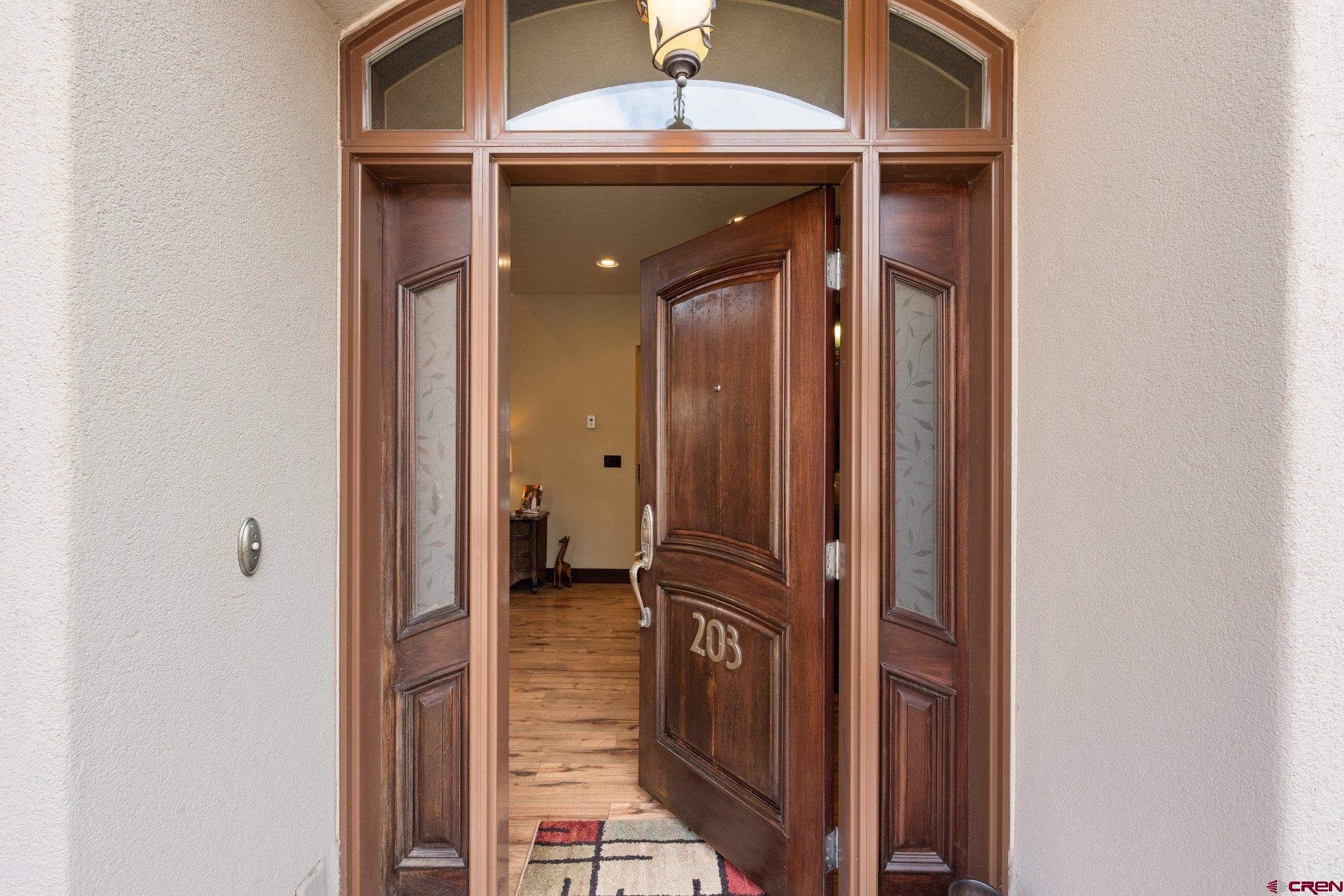 3416 Main Avenue, Unit 203 Durango, CO 81301 - Photo 4 of 34 a view of a hallway with a wooden door