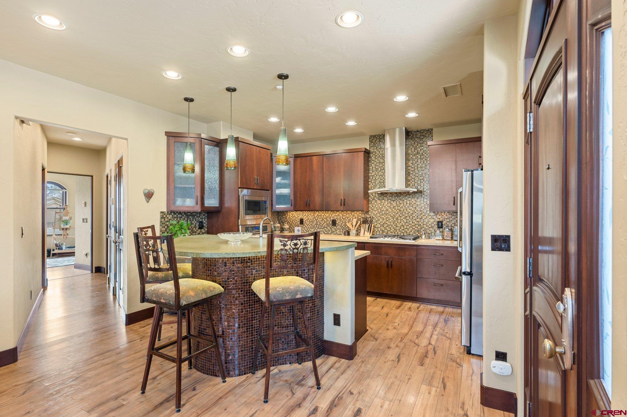 3416 Main Avenue, Unit 203 Durango, CO 81301 - Photo 5 of 34 a kitchen with kitchen island cabinets and wooden floor