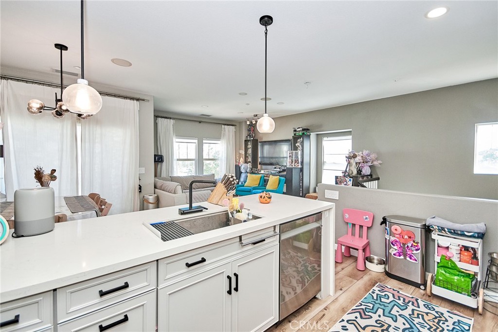 7331 Shelby Place, Unit 8 Rancho Cucamonga, CA 91739 - Photo 15 of 41 a kitchen that has a lot of cabinets a sink and a wooden floor