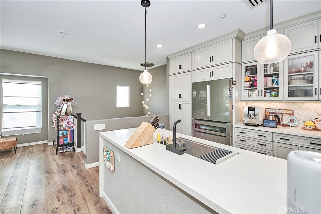 7331 Shelby Place, Unit 8 Rancho Cucamonga, CA 91739 - Photo 18 of 41 a large kitchen with kitchen island a large counter space a sink appliances and cabinets