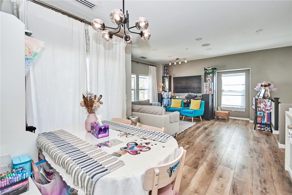 7331 Shelby Place, Unit 8 Rancho Cucamonga, CA 91739 - Photo 21 of 41 a bedroom with a bed and a wooden floor