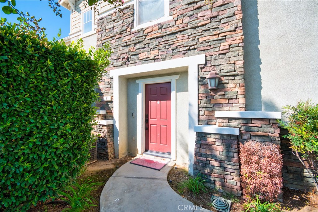 7331 Shelby Place, Unit 8 Rancho Cucamonga, CA 91739 - Photo 3 of 41 a front view of a house with a yard