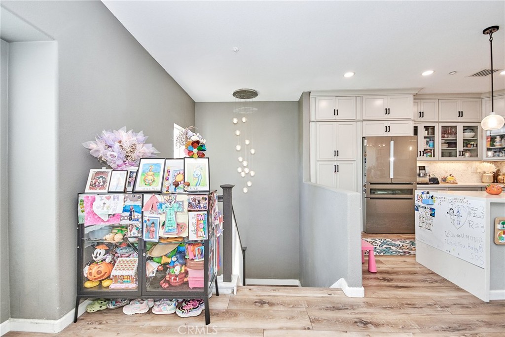 7331 Shelby Place, Unit 8 Rancho Cucamonga, CA 91739 - Photo 6 of 41 a kitchen view with stainless steel appliances kitchen island granite countertop a refrigerator and a sink