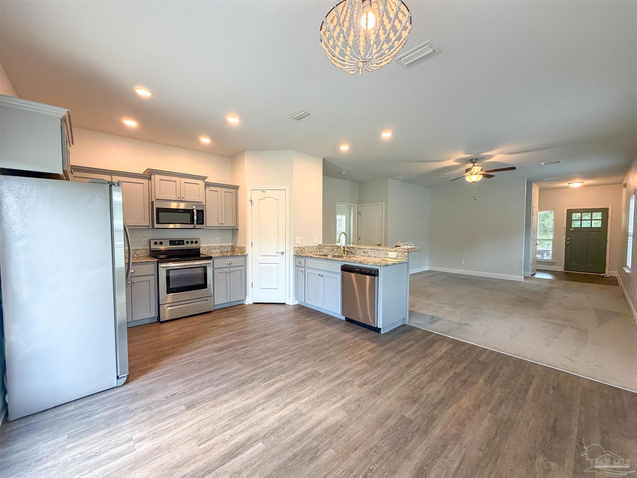 3613 Conley Drive Cantonment, FL 32533 - Photo 5 of 32 a kitchen with a refrigerator and a sink