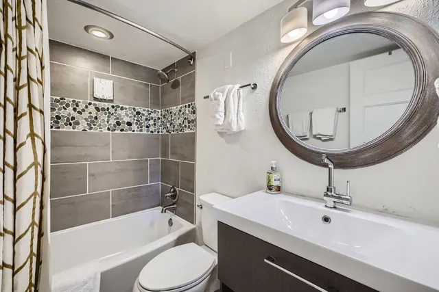a bathroom with a sink a toilet and bathtub