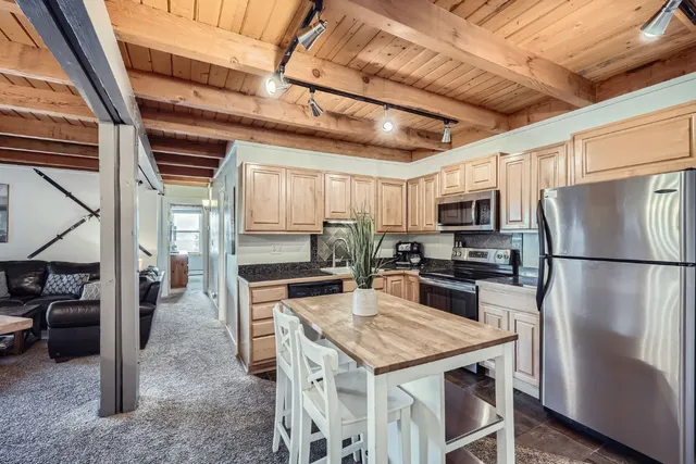 a kitchen with a refrigerator a stove a sink and dishwasher