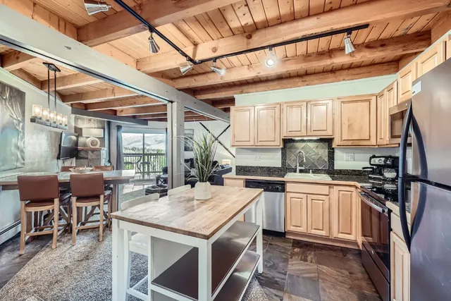a kitchen with stainless steel appliances granite countertop a sink and cabinets
