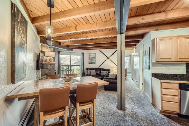 a dining room with furniture a chandelier and fireplace