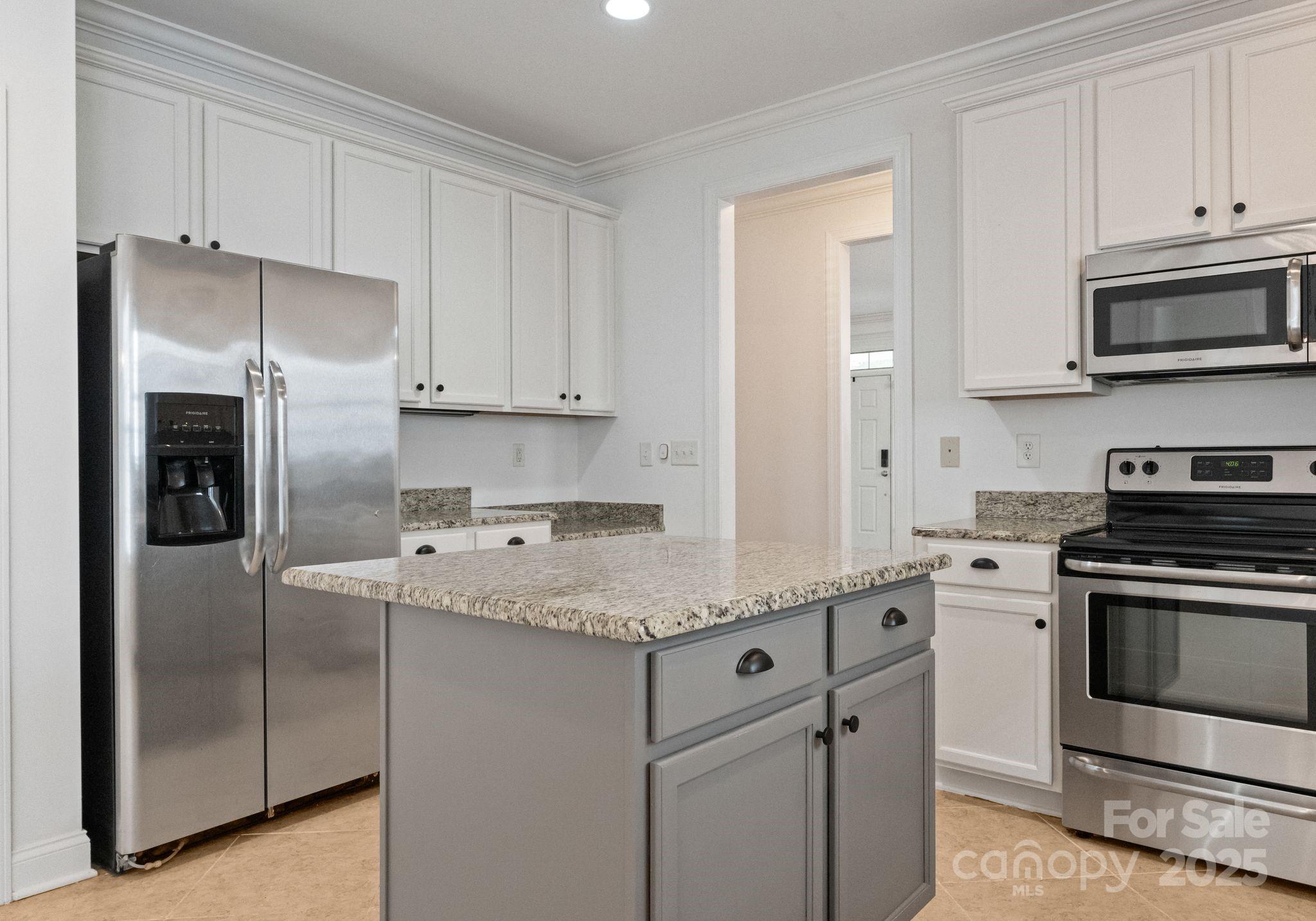 20237 Harroway Drive Cornelius, NC 28031 - Photo 11 of 23 a kitchen with stainless steel appliances granite countertop a stove a refrigerator and a microwave