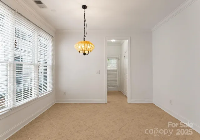 a view of an empty room with window and cabinet