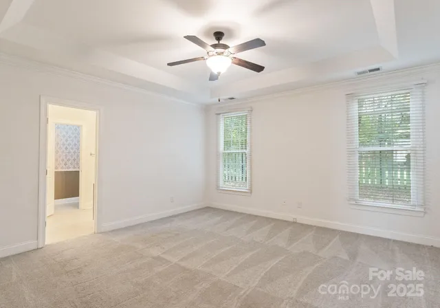 a view of a livingroom with a ceiling fan and window