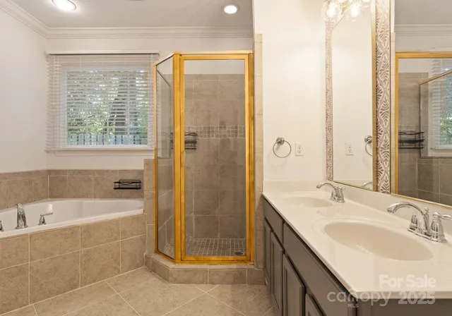 a bathroom with a granite countertop sink and a bathtub