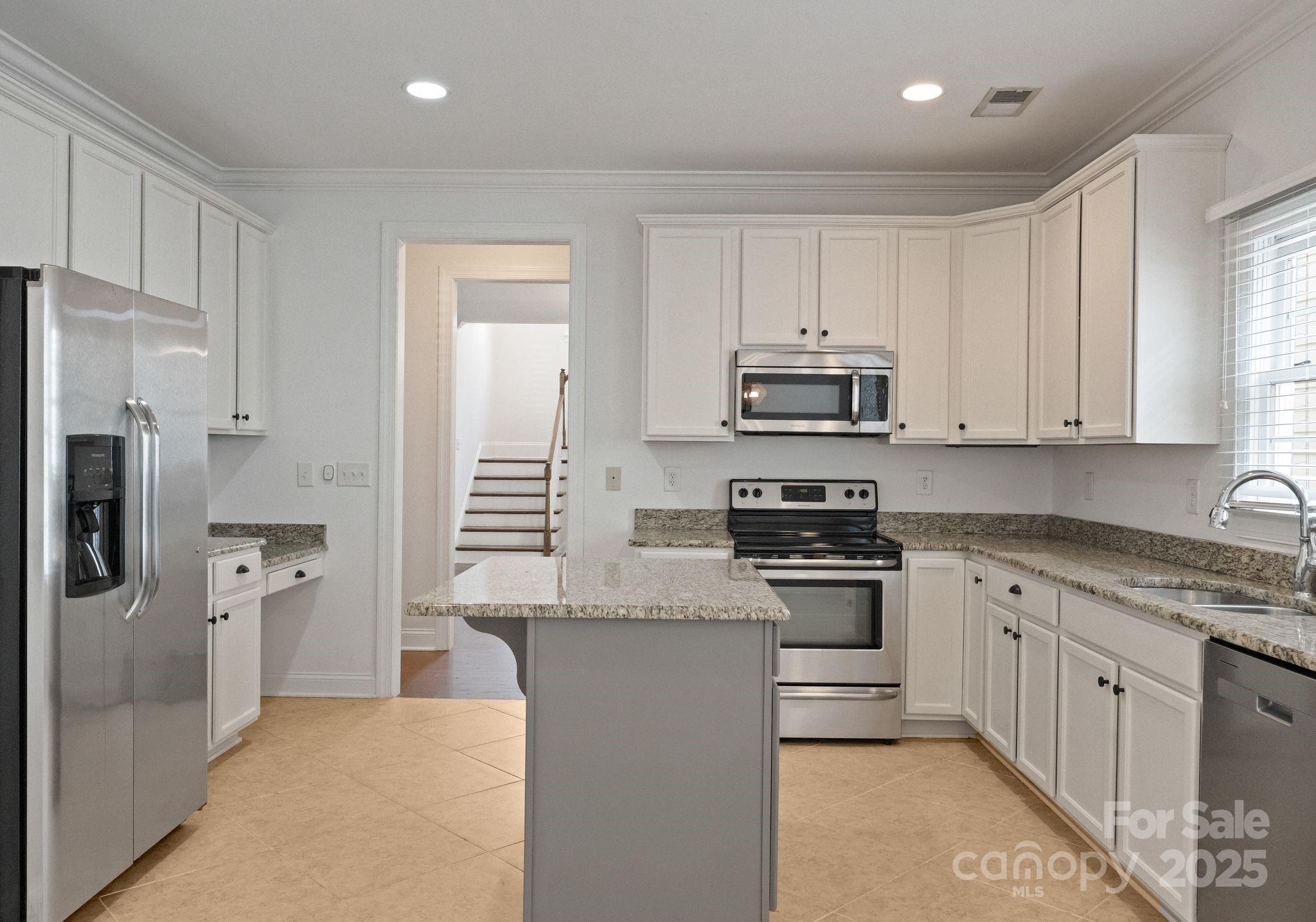20237 Harroway Drive Cornelius, NC 28031 - Photo 9 of 23 a kitchen with stainless steel appliances granite countertop a stove a refrigerator and a sink