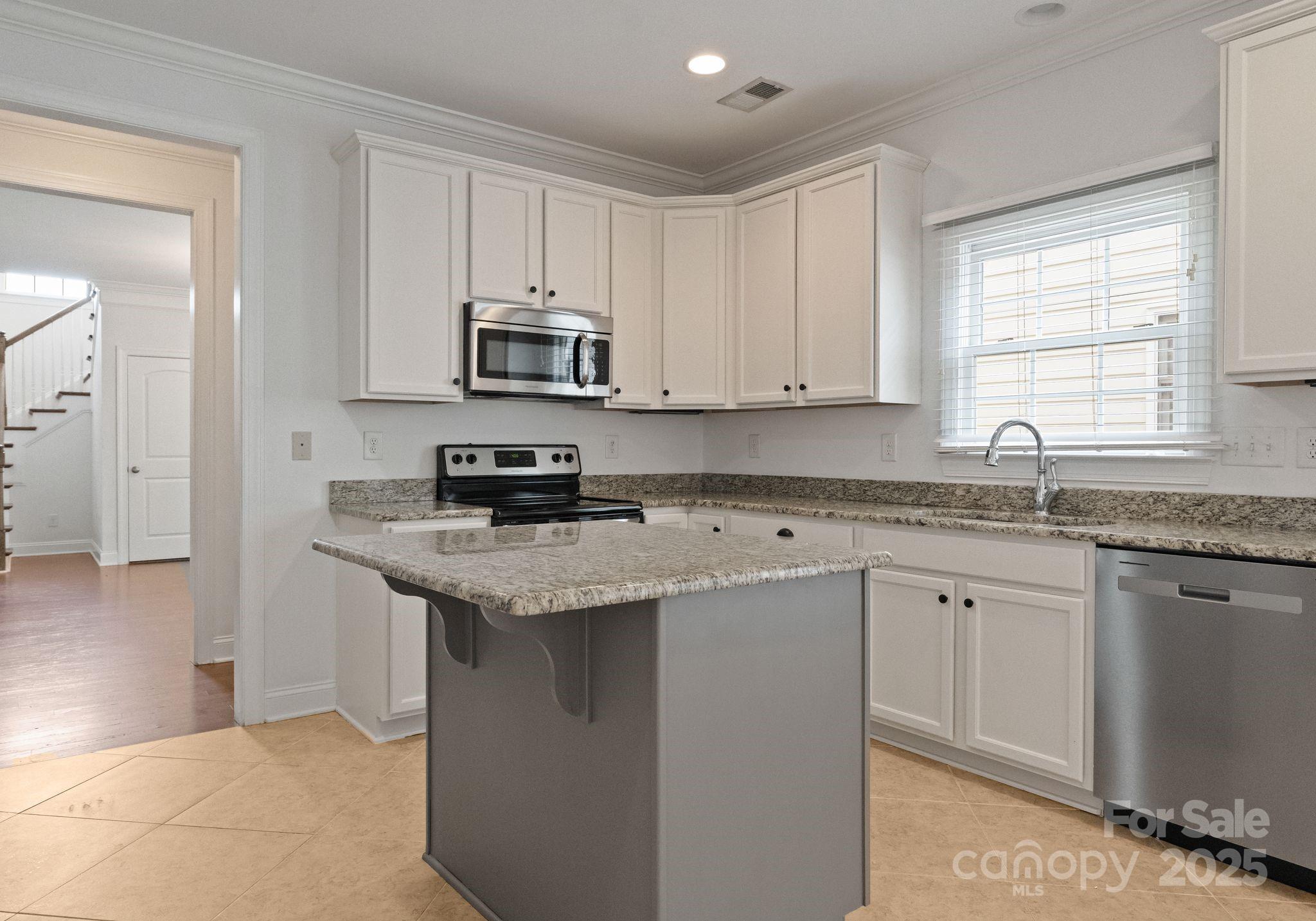 20237 Harroway Drive Cornelius, NC 28031 - Photo 10 of 23 a kitchen with granite countertop a sink stove and cabinets