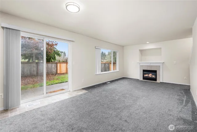 a view of a kitchen with refrigerator and cabinets