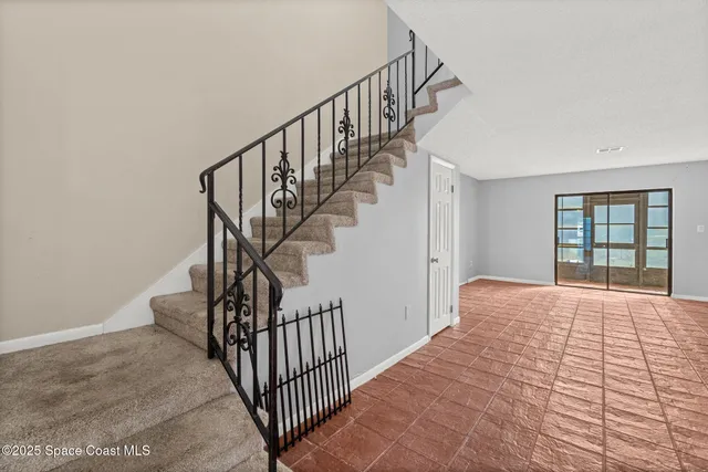 an empty room with fan and windows