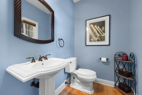 a bathroom with a toilet a sink and mirror