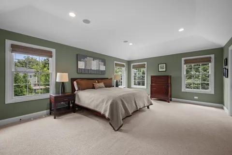 a spacious bedroom with a large bed and a window